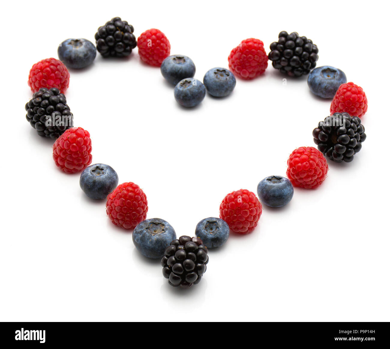 Heart by berries isolated on white background blackberry blueberry and ...