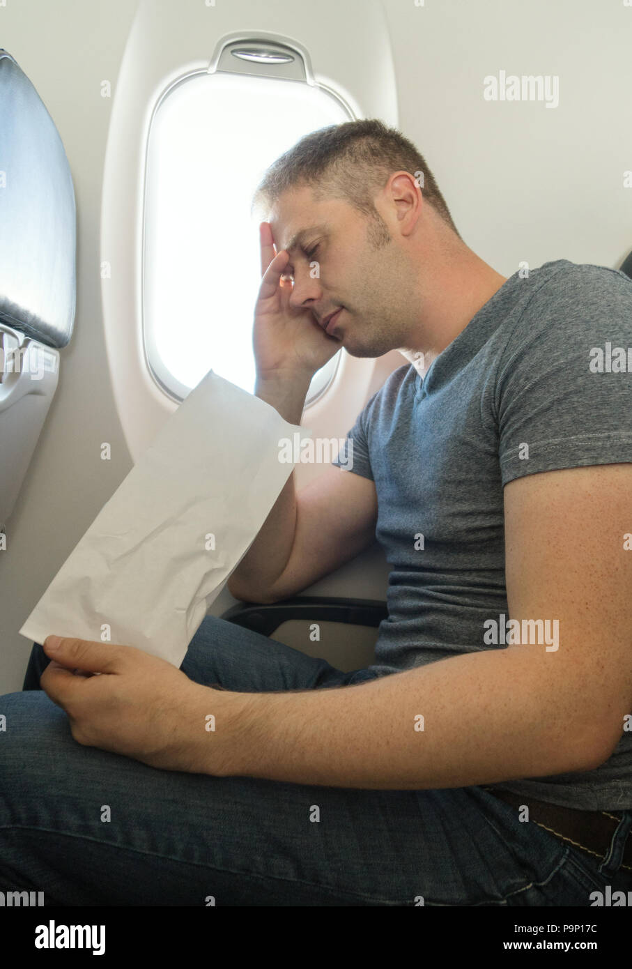 Airsickness. Man feels very bad on the plane. Stock Photo