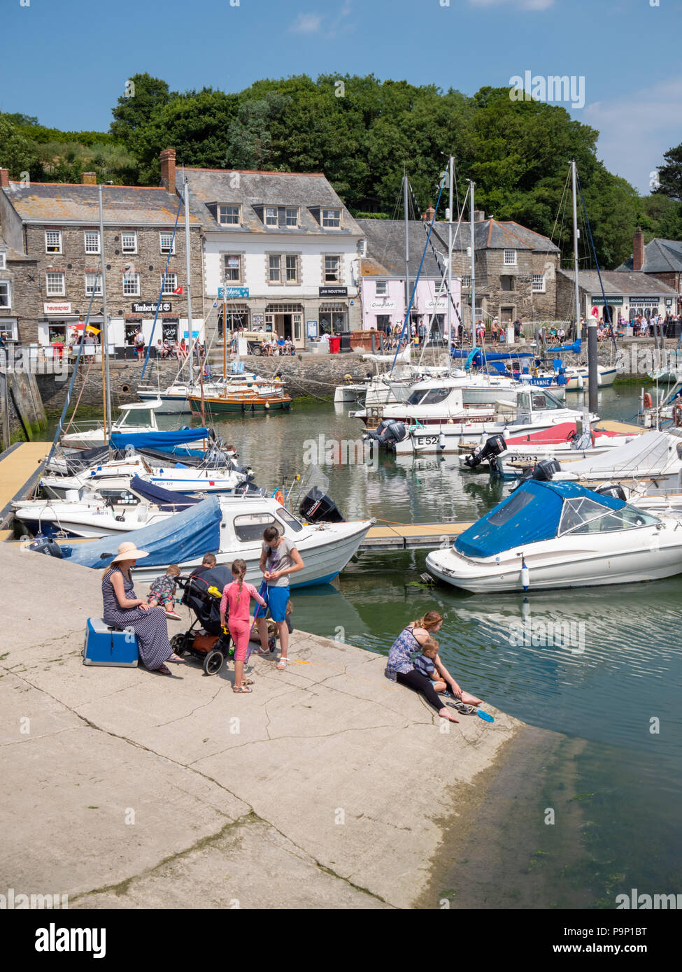 Tourists enjoying hot sunny weather outside at Padstow harbour Cornwall