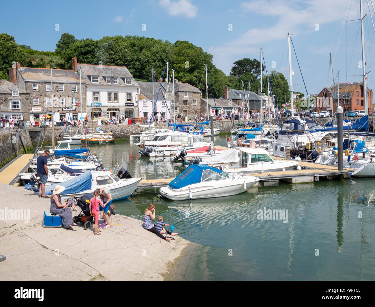 Tourists enjoying hot sunny weather outside at Padstow harbour Cornwall