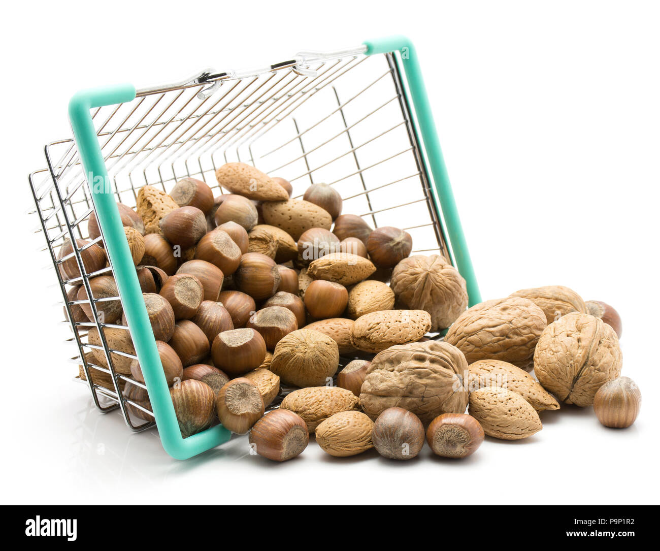 Nuts mix (walnut, hazelnut and almond) out a shopping basket isolated on white background Stock Photo
