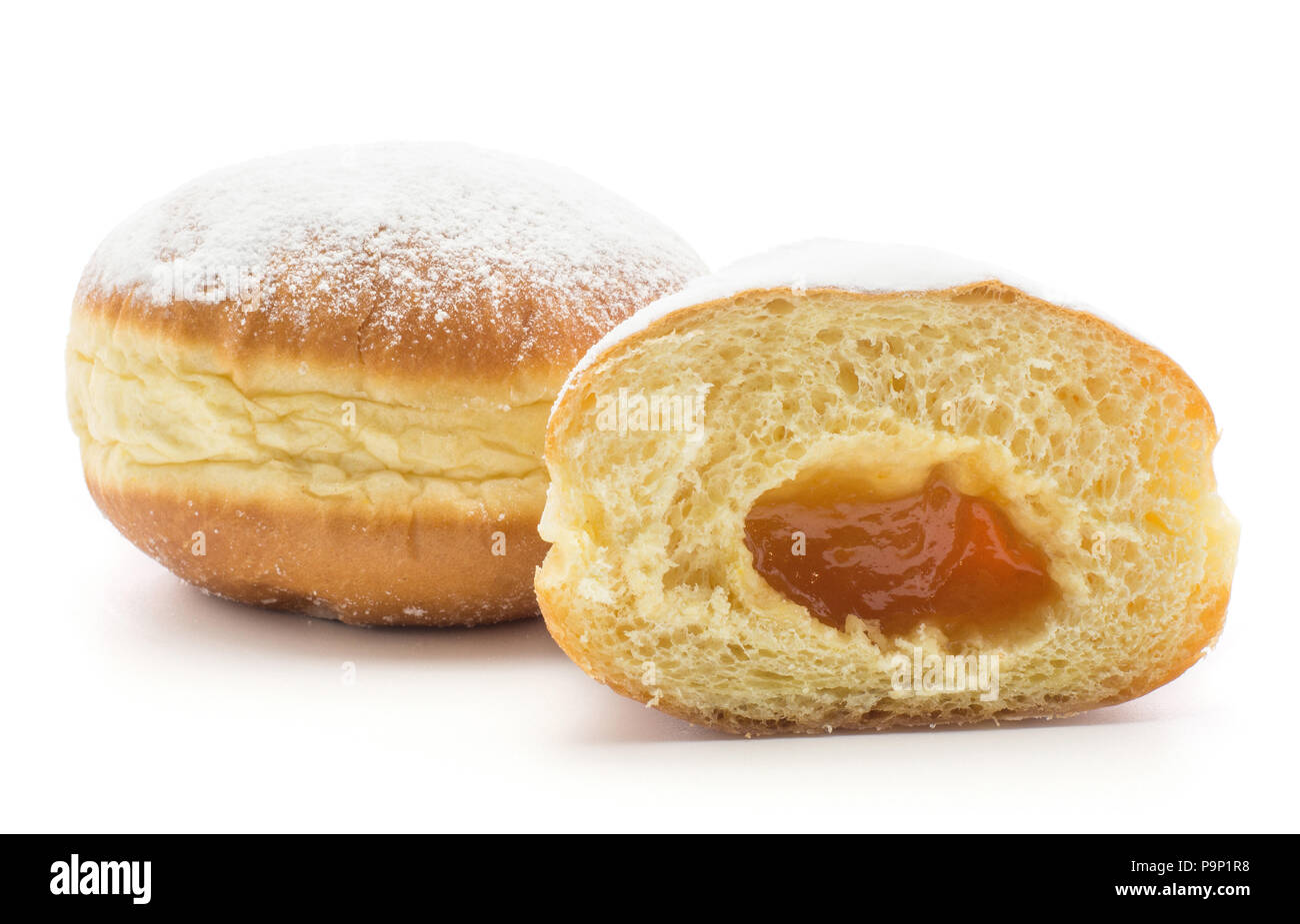 Traditional doughnut (Sufganiyah) and one half with apricot jam ...