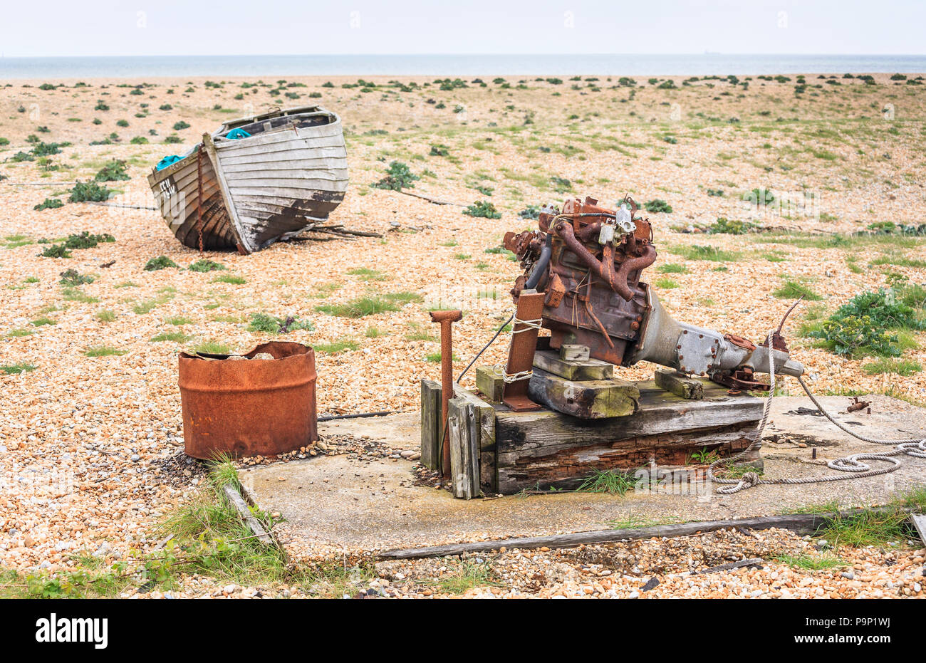 Abandoned wooden fishing boat and rusty engine on the foreshore of the ...