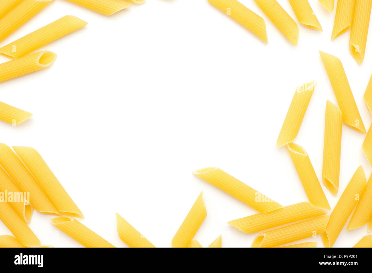 Penne rigate top view isolated on white background raw pasta pieces Stock Photo