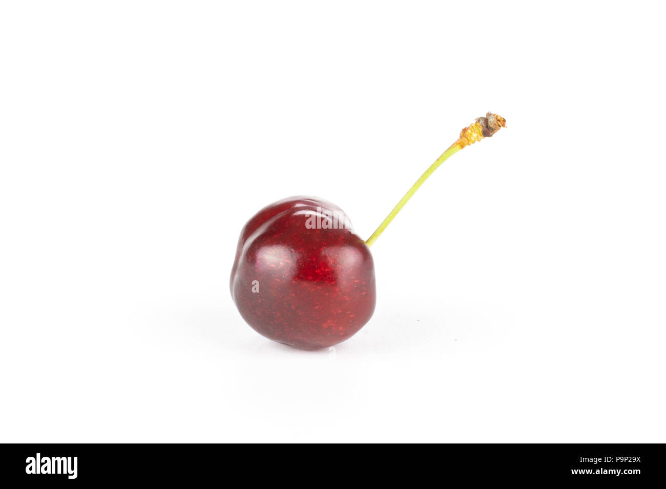 One whole sweet bright red cherry with a stem side look isolated on white Stock Photo