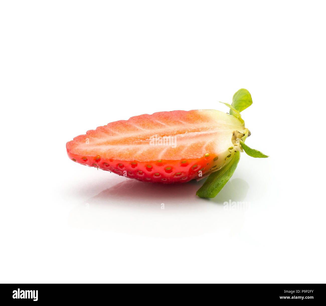 One garden strawberry half isolated on white background fresh cut Stock Photo