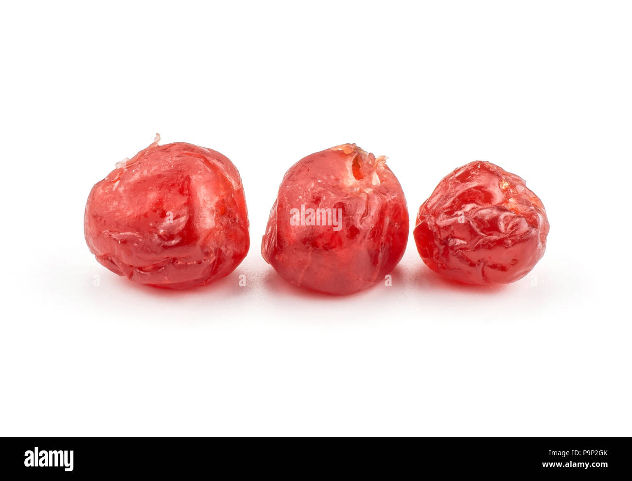 Three red dry cherries isolated on white background in row Stock Photo