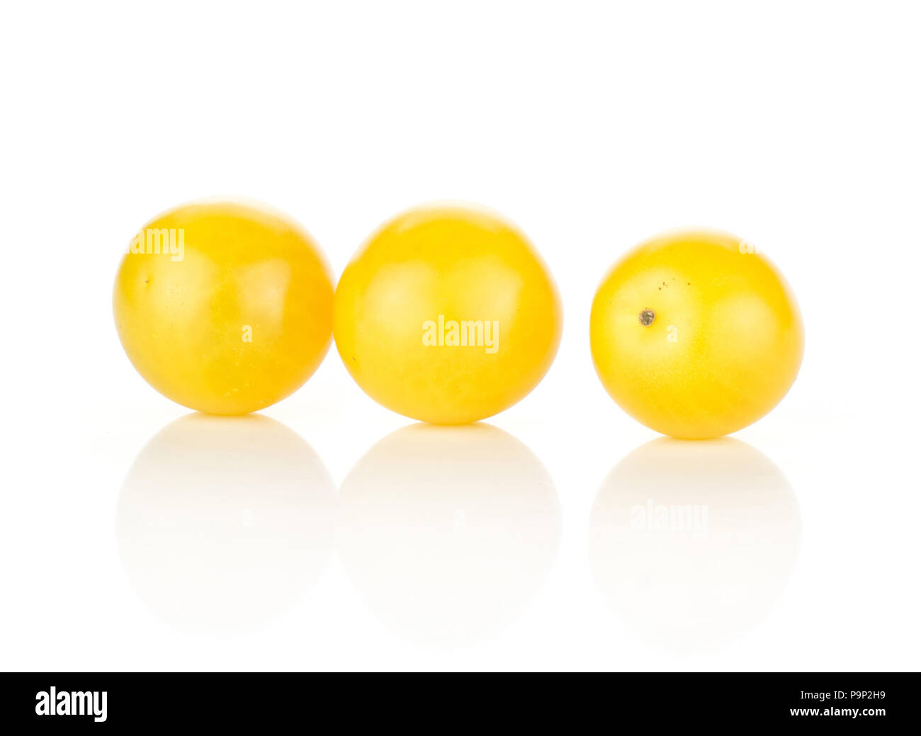Three yellow grape cherry tomatoes isolated on white background Stock Photo