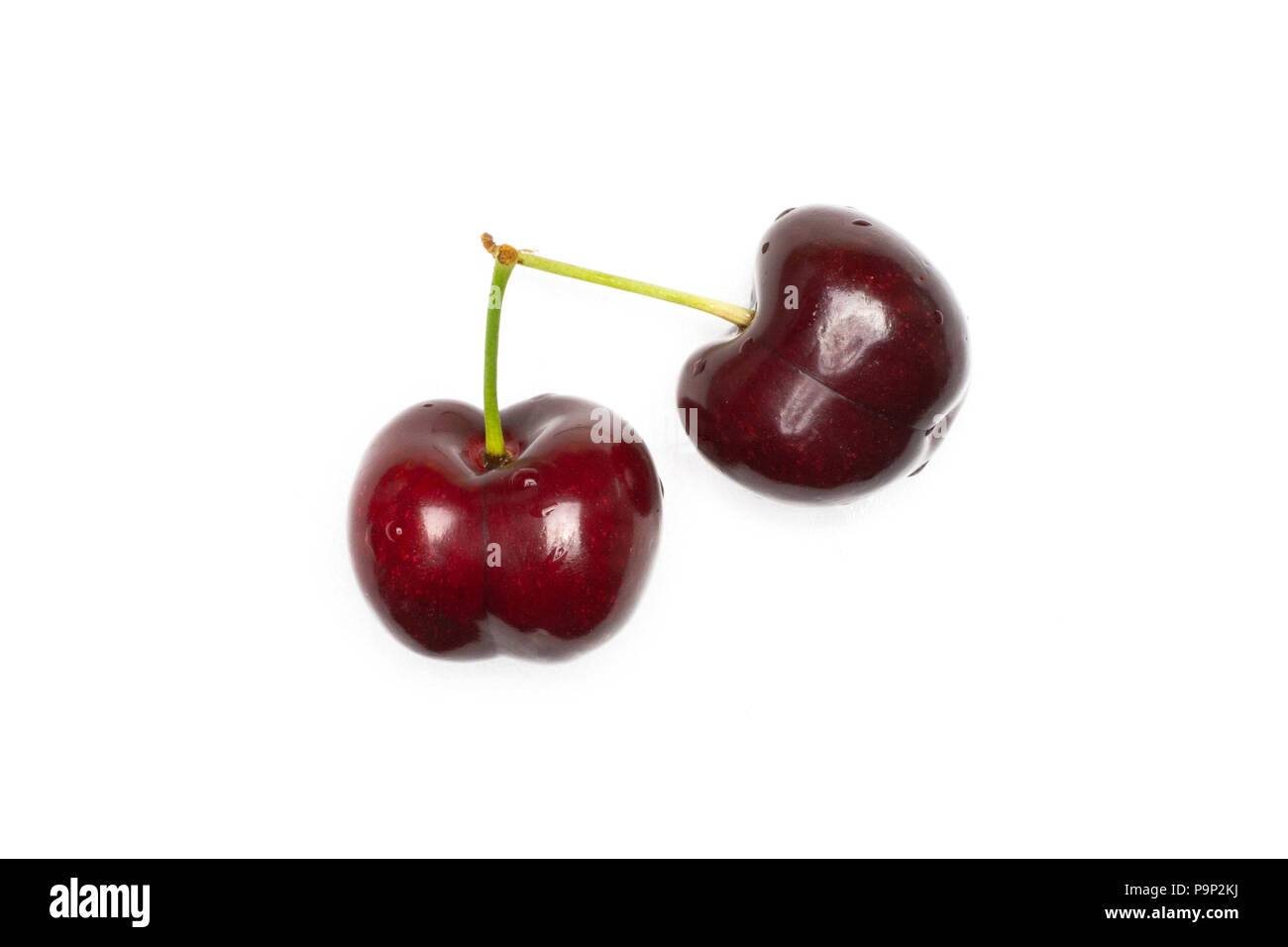 Group of two whole sweet bright red cherry with a stem flatlay isolated on white Stock Photo