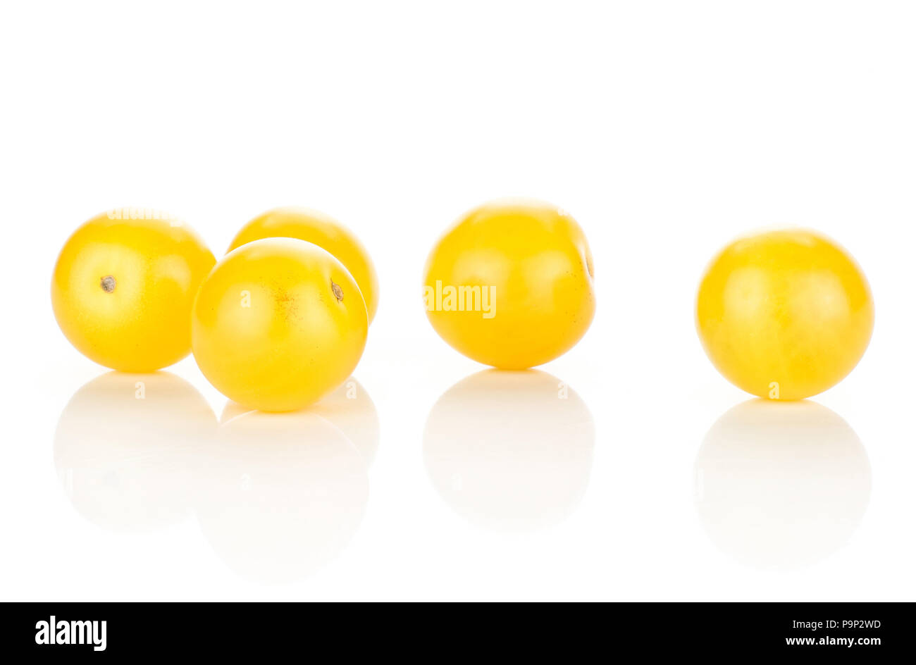 Five yellow grape cherry tomatoes isolated on white background Stock Photo