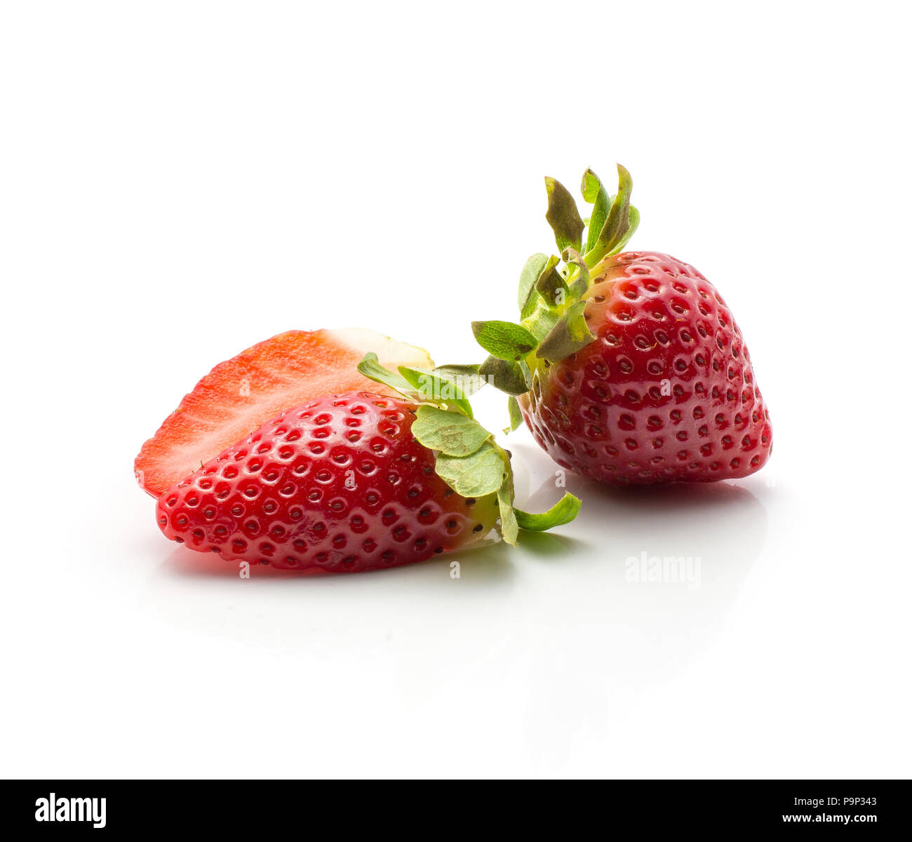 Sliced garden strawberry and one whole isolated on white background Stock Photo