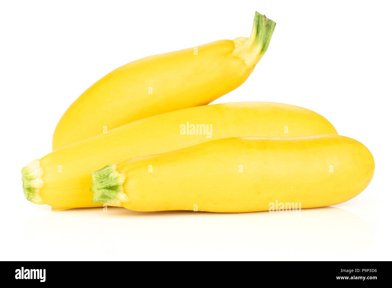 Group of three whole raw yellow zucchini isolated on white Stock Photo