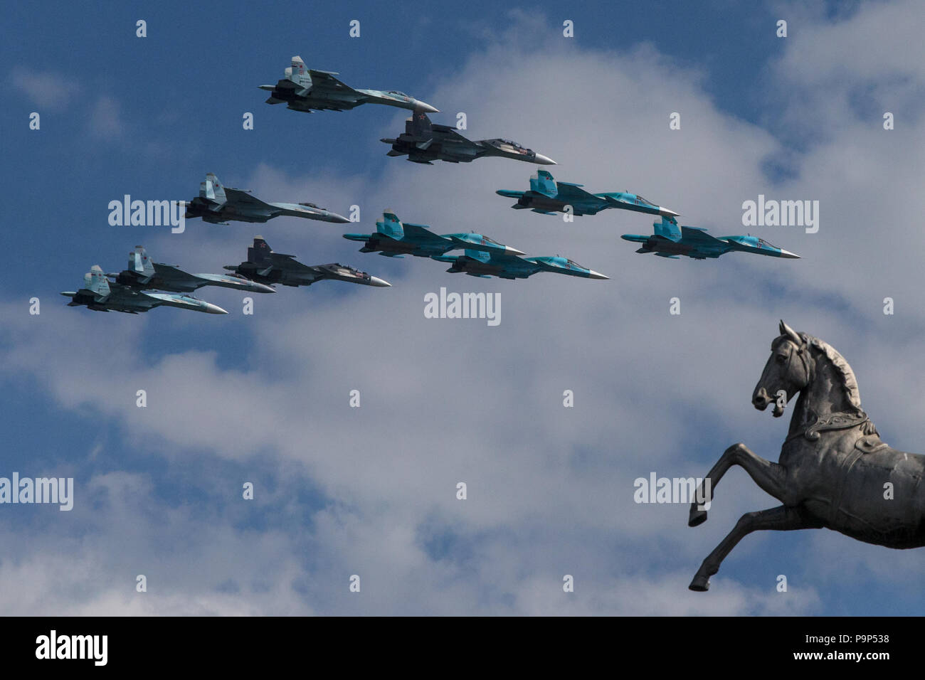 Ten Sukhoi fighter jets of Russian Air Force (four Su-27, four Su-34 and two Su-35) fly in formation over Moscow hippodrome during a rehearsal for the Stock Photo