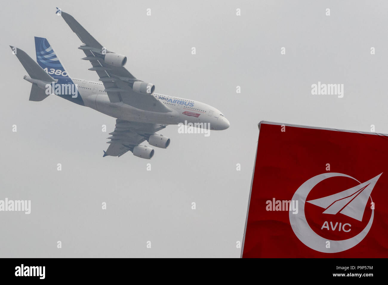 The Airbus A380 widebody civil jet airplane flies over the logo of AVIC (Aviation Industry Corporation of China) as seen at the China Airshow-2014, Zh Stock Photo