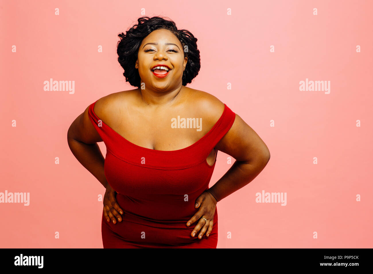 Happy confident satisfied curvy woman smiling Stock Photo