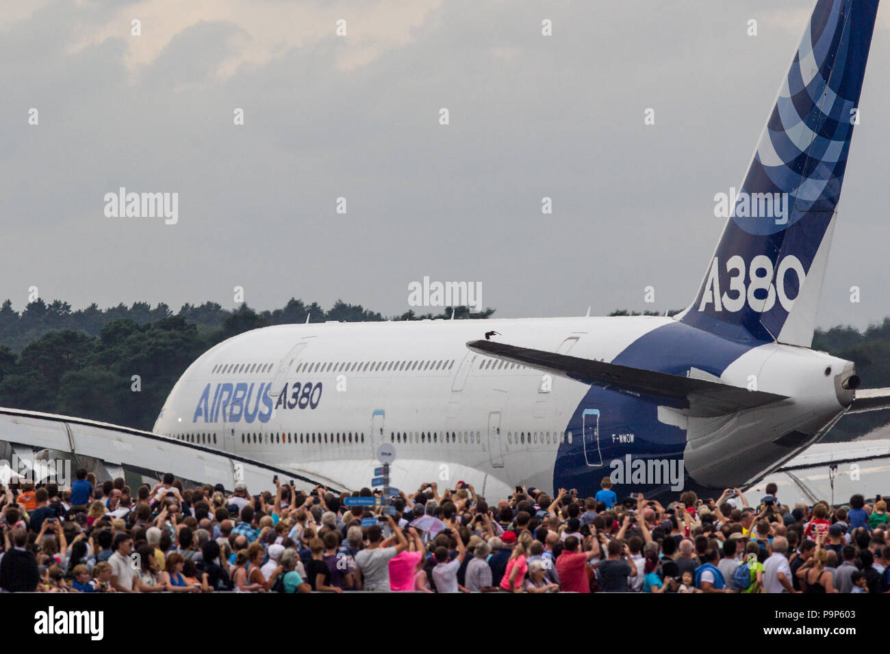 Visitors to the airshow watch the Airbus A380 civil airplane at the Farnborough International Airshow, UK Stock Photo