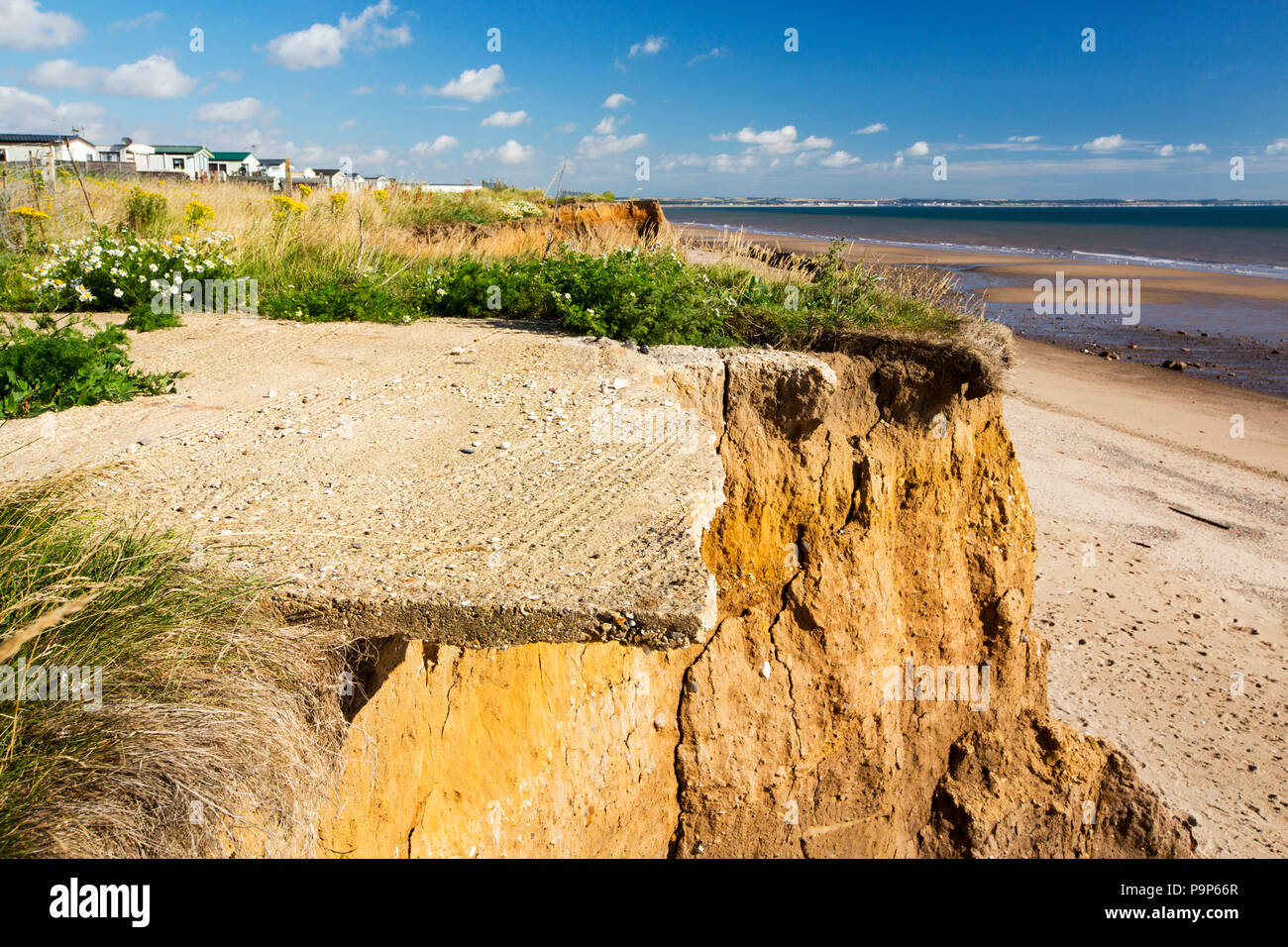 A collapsed concrete caravan base near Aldbrough on Yorkshires East Coast, near Skipsea, UK. The coast is composed of soft boulder clays, very vulnerable to coastal erosion. This section of coast has been eroding since Roman times, with many villages having disappeared into the sea, and is the fastest eroding coast in Europe. Climate change is speeding up the erosion, with sea level rise, increased stormy weather and increased heavy rainfall events, all playing their part. Stock Photo