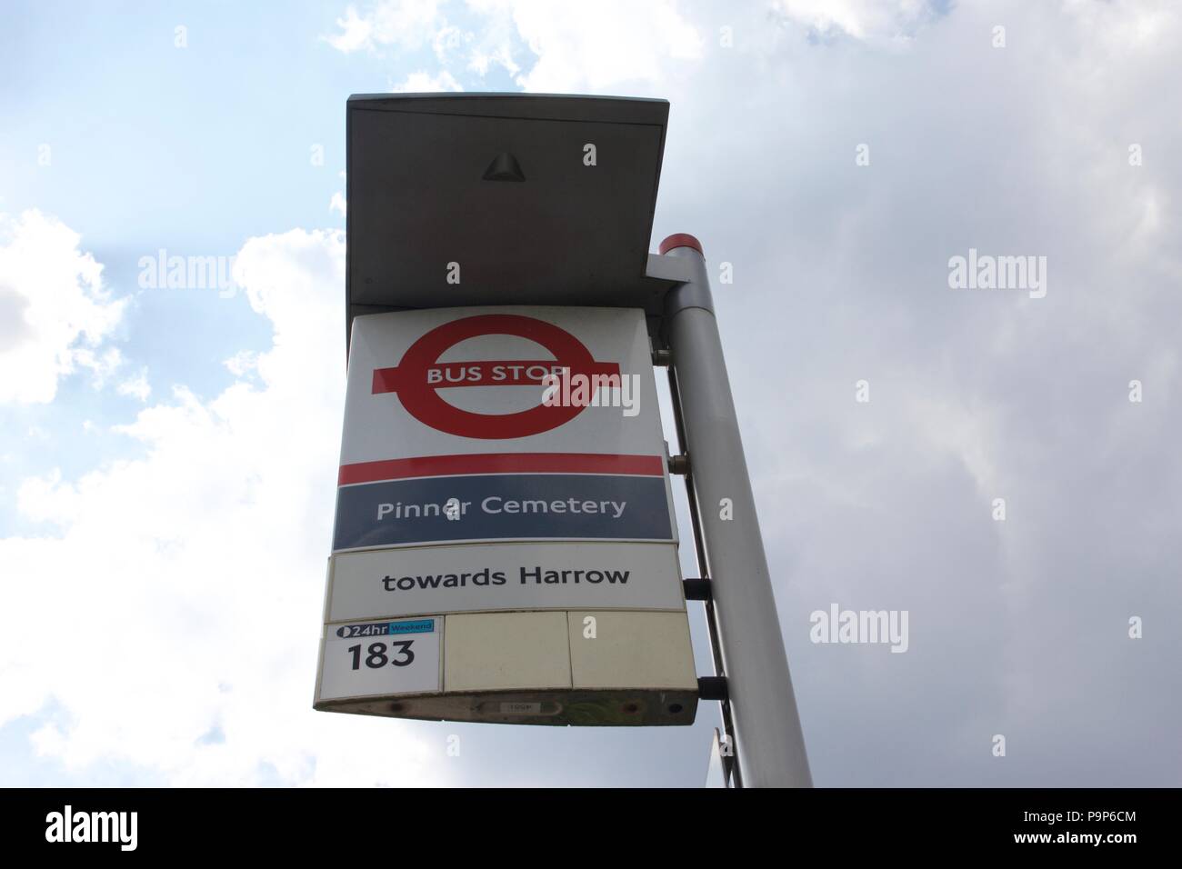 London Bus stop called Pinner Cemetery towards Harrow, with the bus number 183 that stops at it