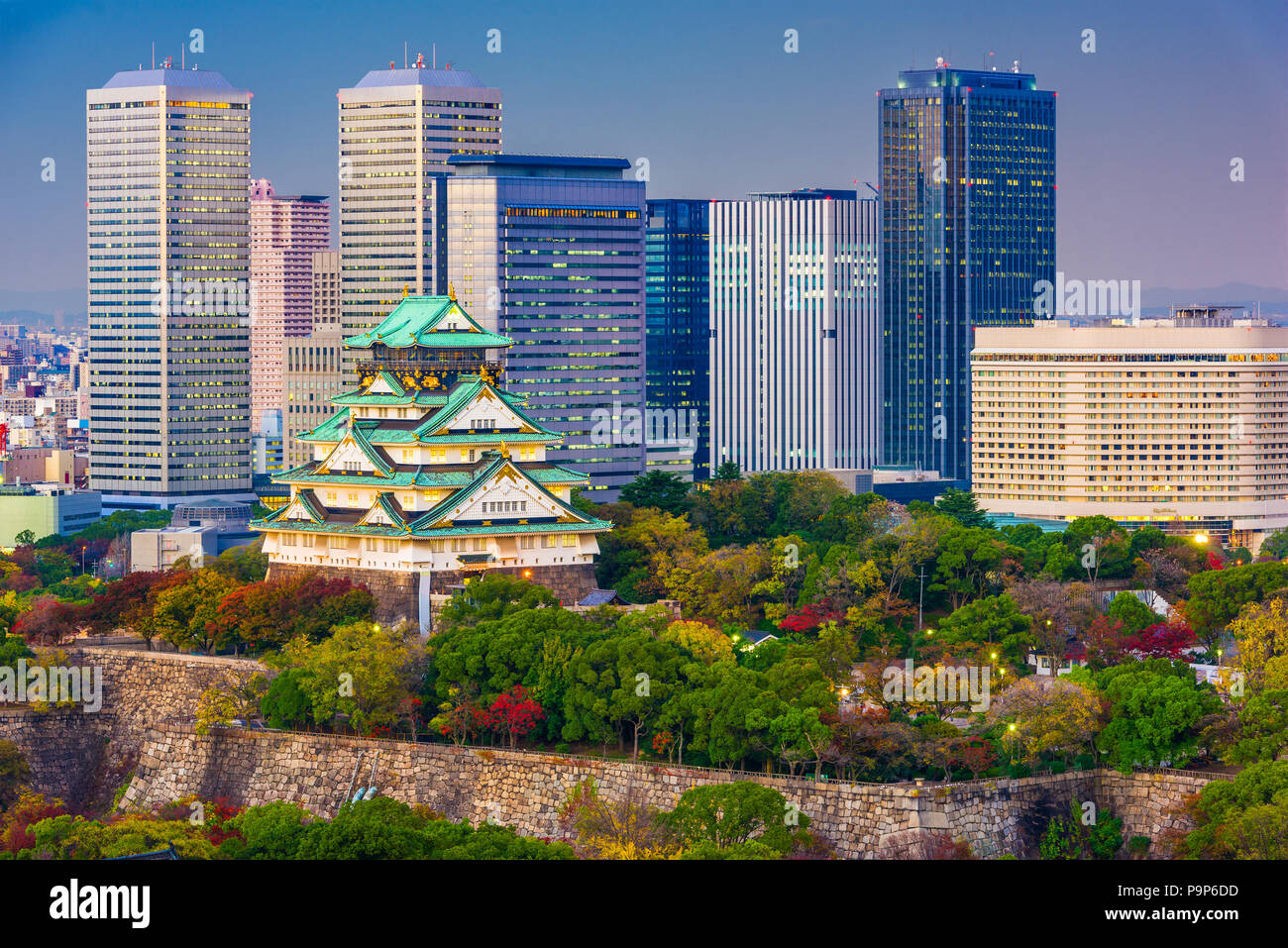 Osaka, Japan city skyline at the castle and business park at dusk in autumn. Stock Photo