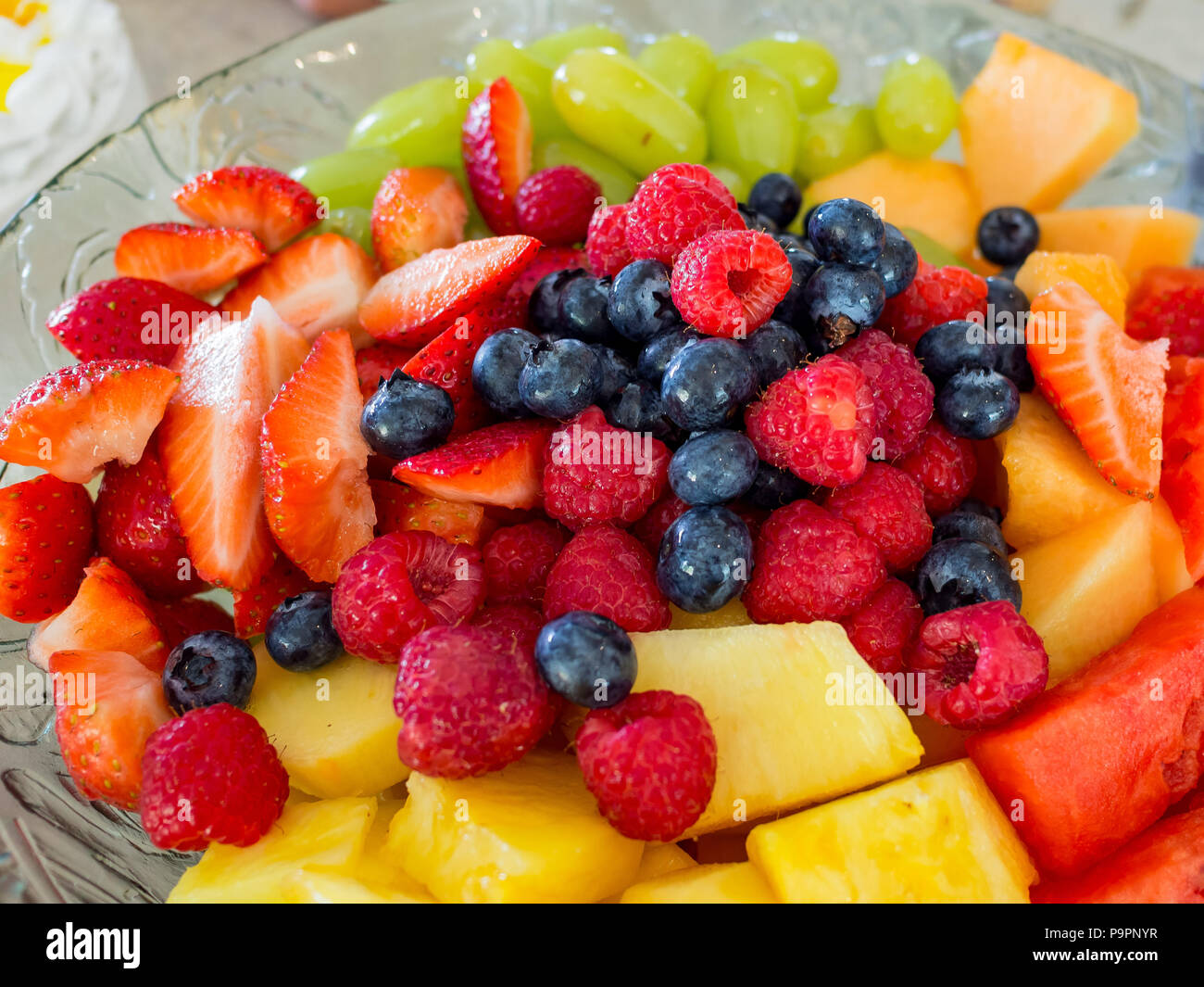 Close up shot of many fruits, inculding strawberry, blueberry, melon