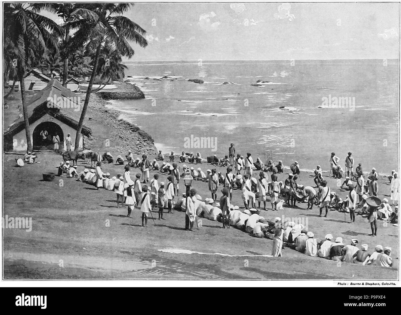 . PRISONERS IN THE ANDAMAN ISLANDS. The little group of the Andaman Islands lies in the Bay of Bengal, some six hundred miles to the south of Calcutta. In 1858 a convict settlement was established at Port Blair, on the principal island, and to it were sent a large number of the Sepoy mutineers. The island has now become a general convict station for prisoners under life-sentences. It is a group of these men that we see in our illustration assembled on the shore for their mid-day meal. It was at Port Blair that Lord Mayo, Viceroy of India, was treacherously murdered by one of the convicts in th Stock Photo