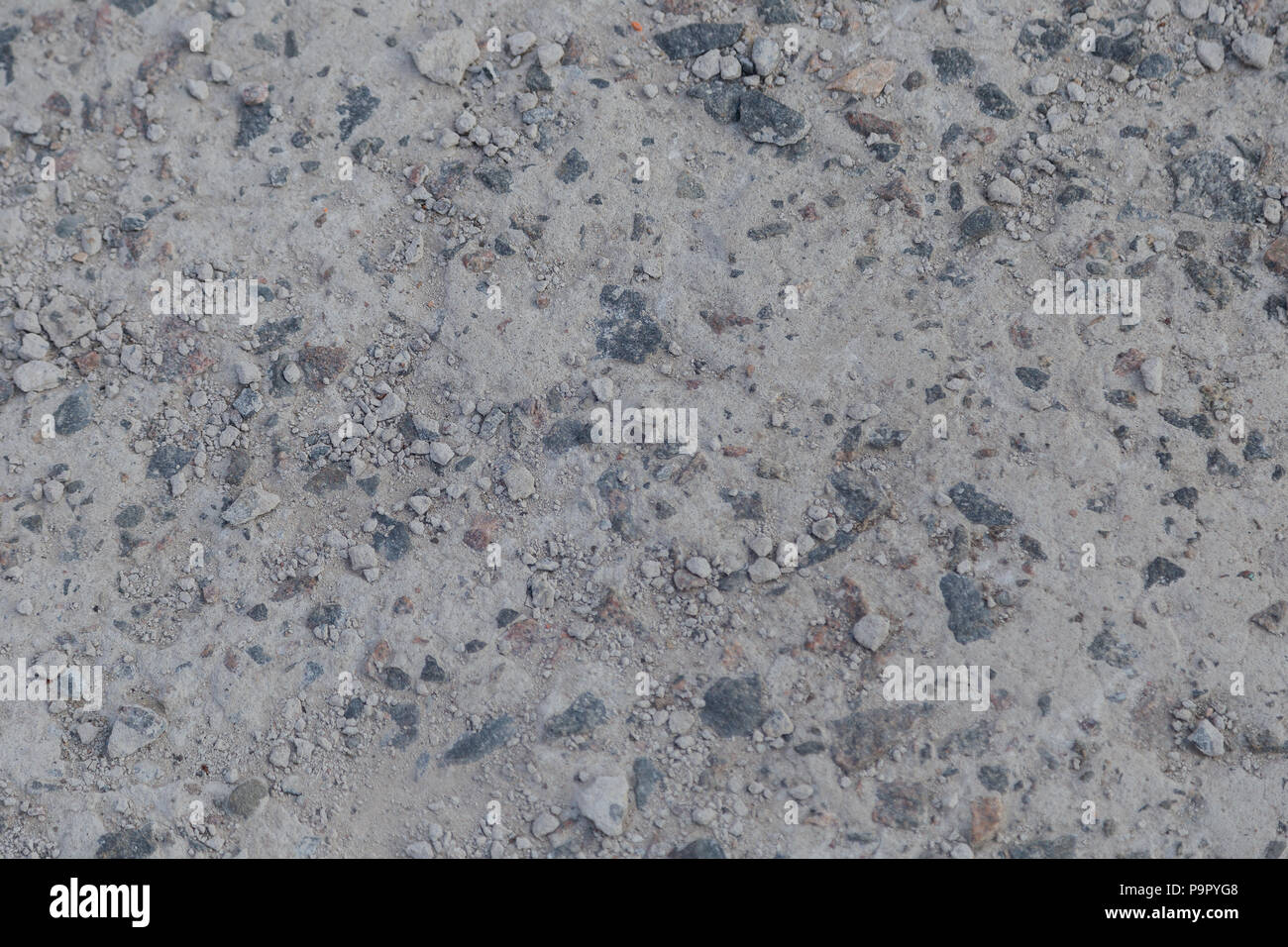 Concrete background with stone impregnations and sand. Stock Photo
