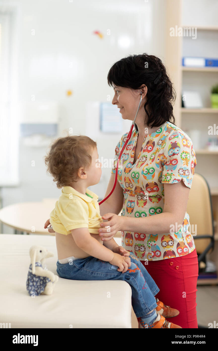 Doctor examining little kid with stethoscope Stock Photo