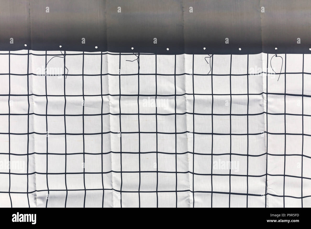 metal wire grid and protective building cloth fenced construction area Stock Photo