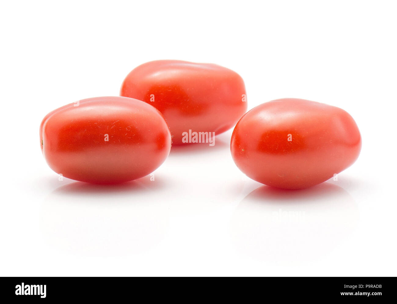 Three cherry tomatoes isolated on white background Stock Photo