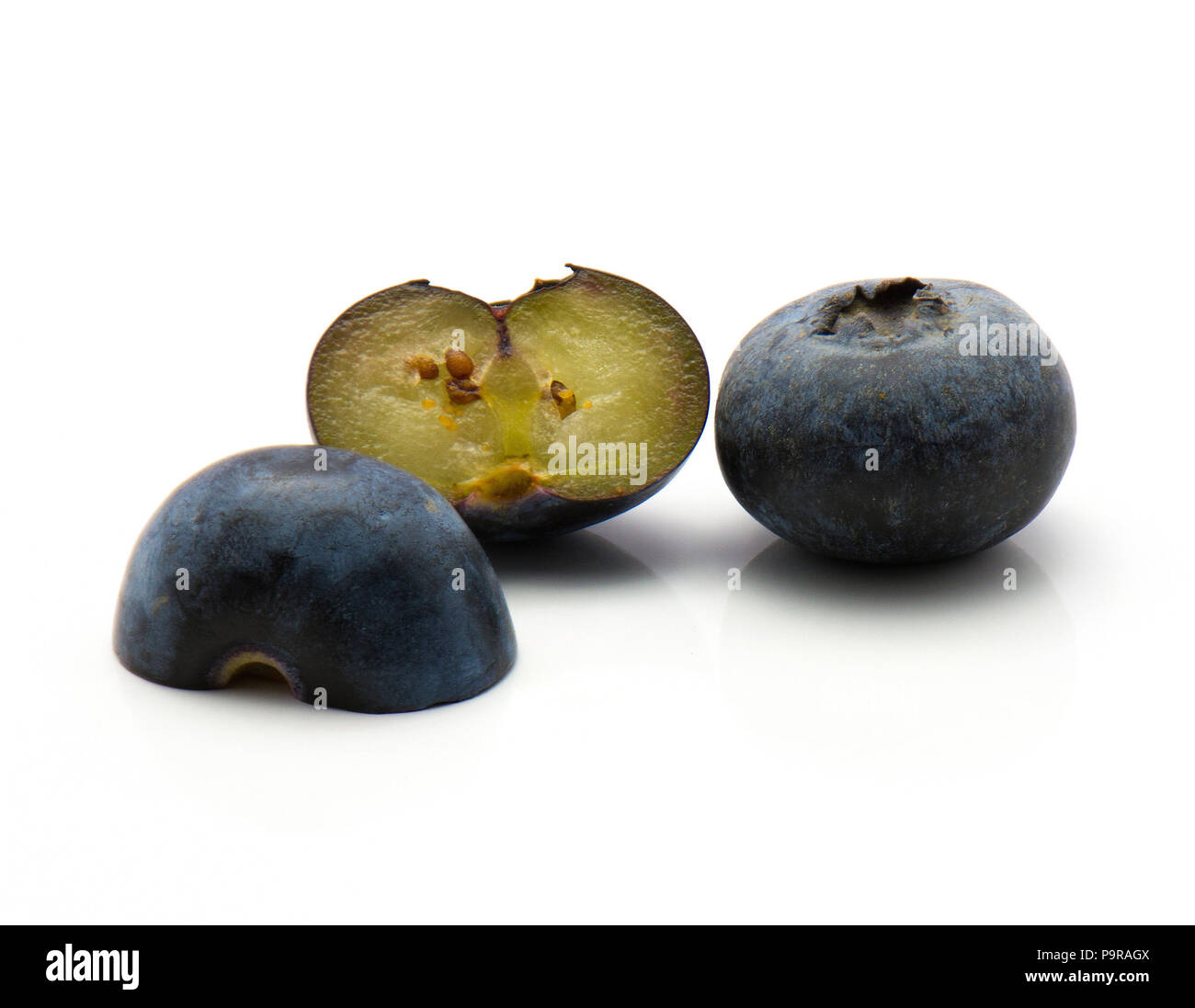 Bog blueberries isolated on white background two halves and one whole Stock Photo