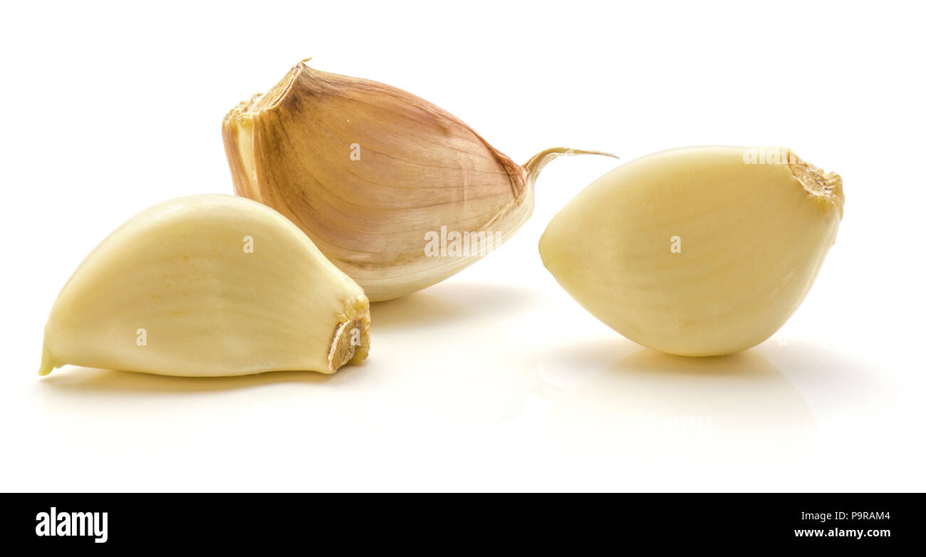 Three garlic cloves isolated on white background Stock Photo - Alamy
