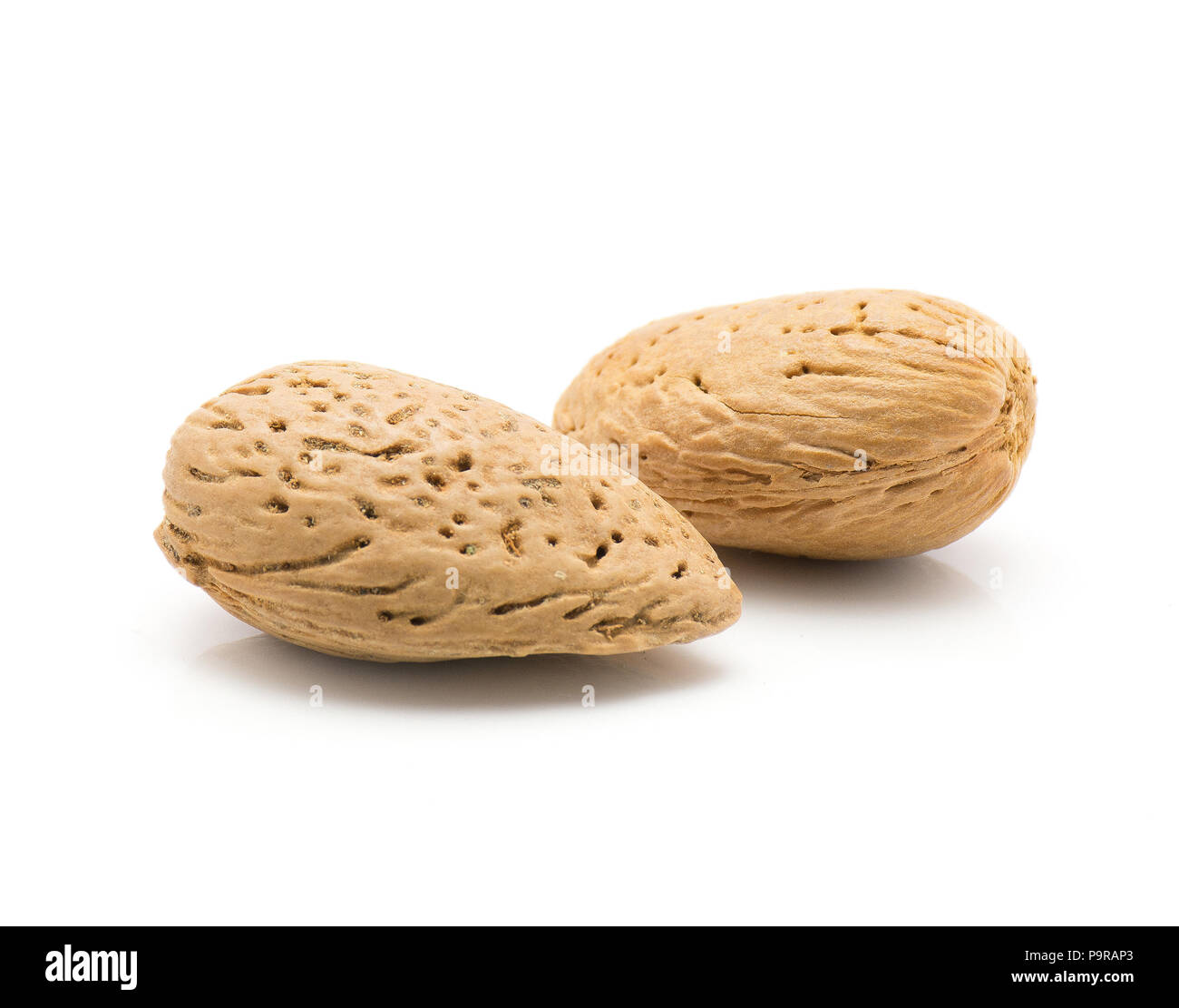 Two unshelled almonds isolated on white background Stock Photo