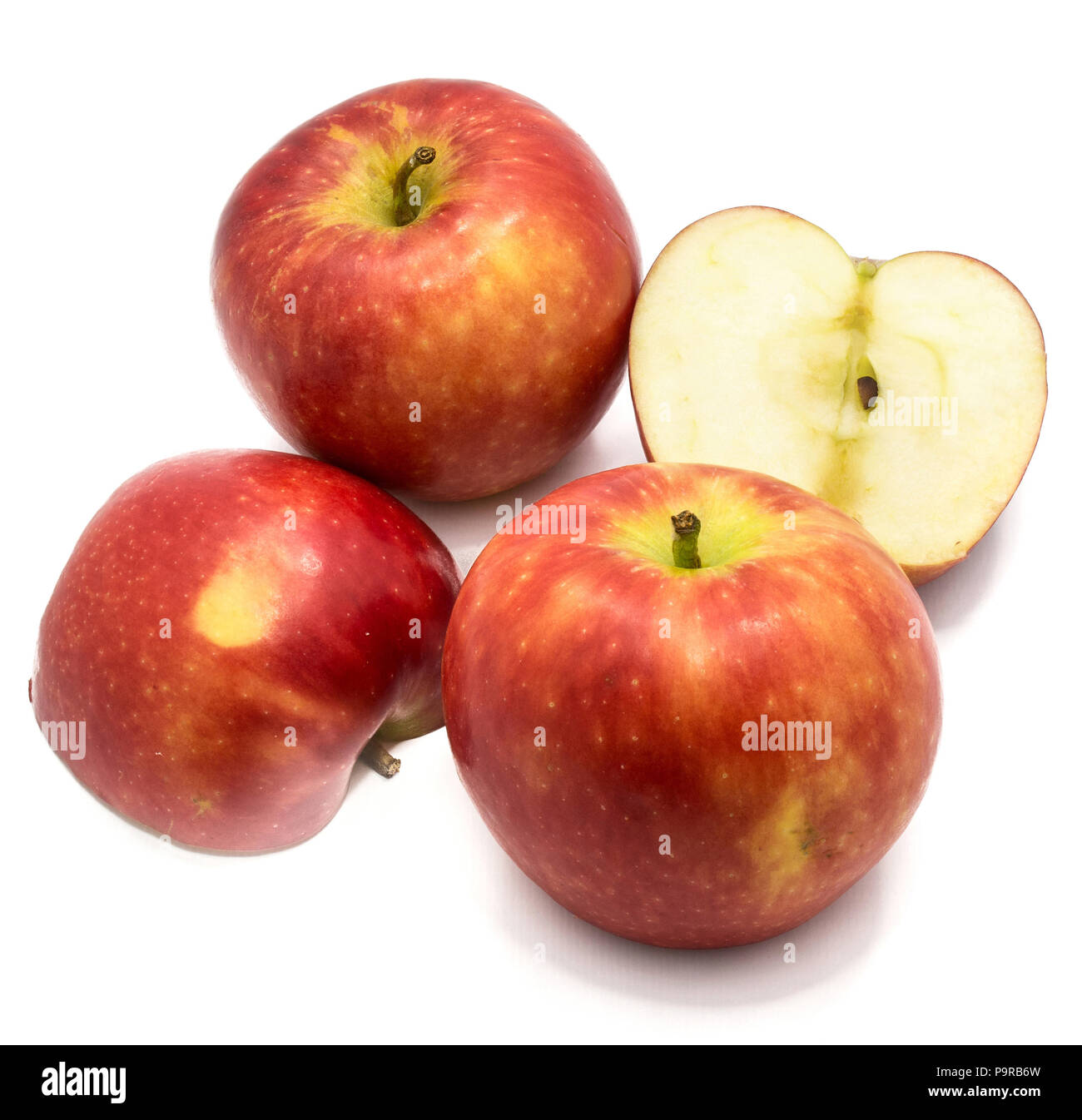 Red Kanzi apples, two whole, two halves, isolated on white background