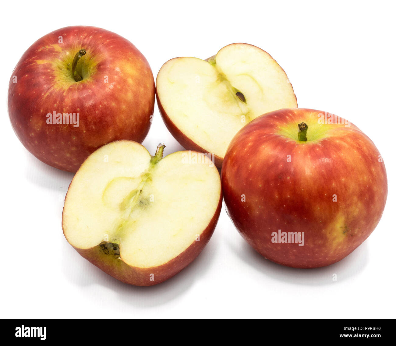 Red Kanzi apples, two whole, two halves, isolated on white background