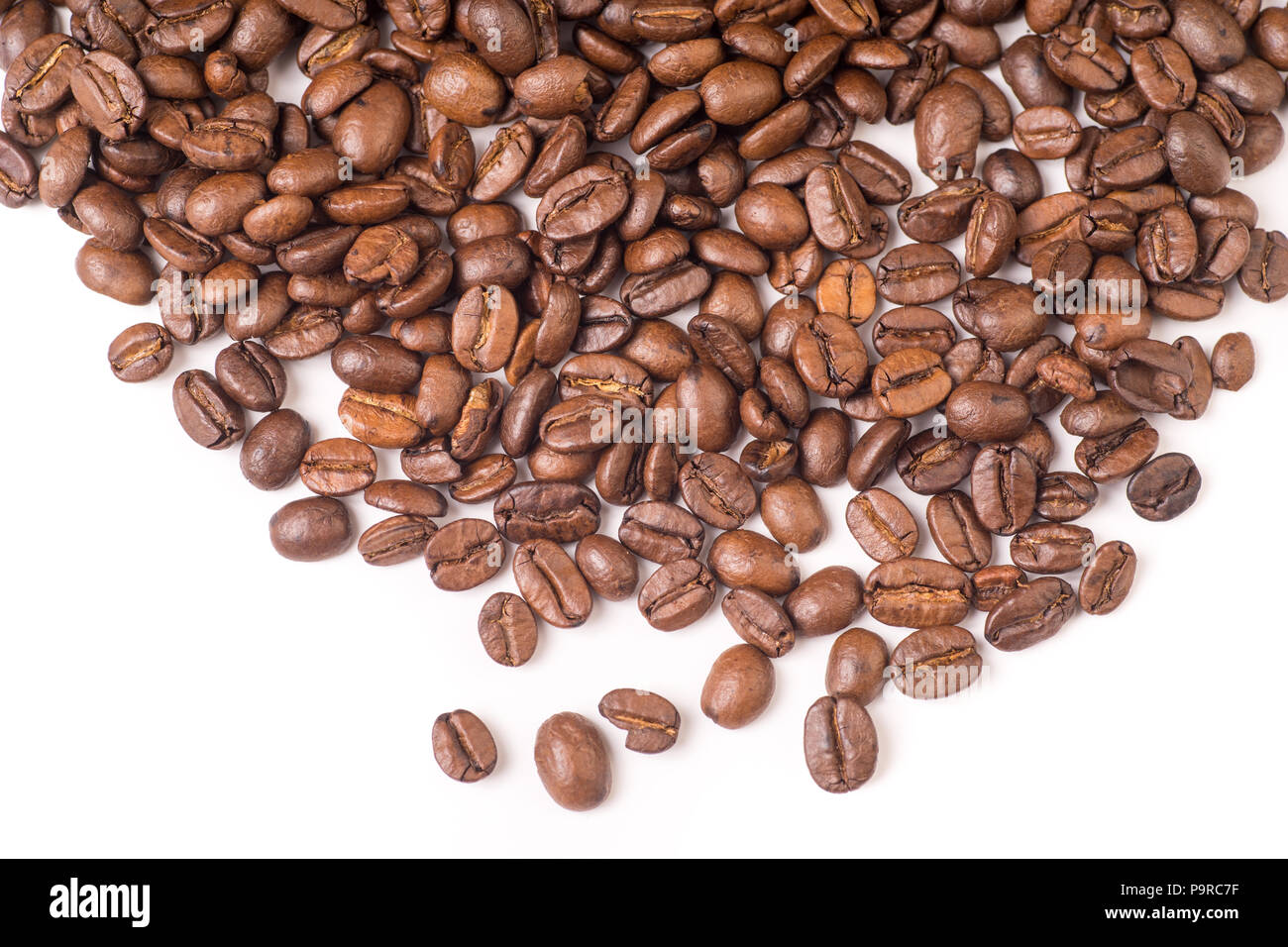 Roasted organic whole dark coffee beans, isolated on white background ...