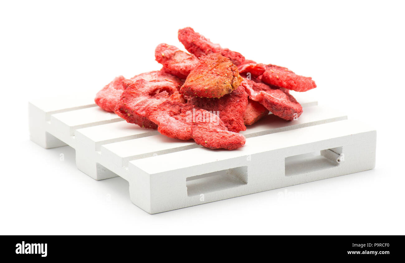 Freeze dried strawberries on a pallet isolated on white background Stock Photo