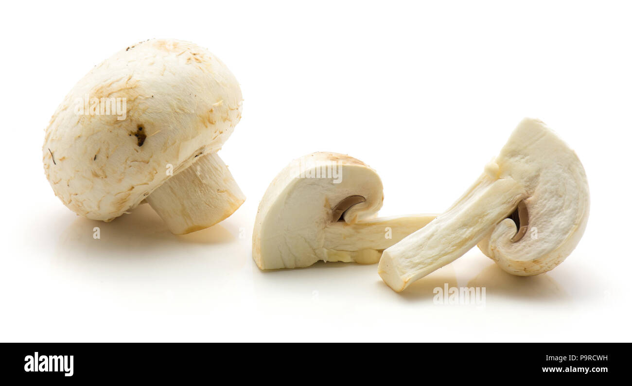 Champignons sliced isolated on white background one whole two quarters Stock Photo