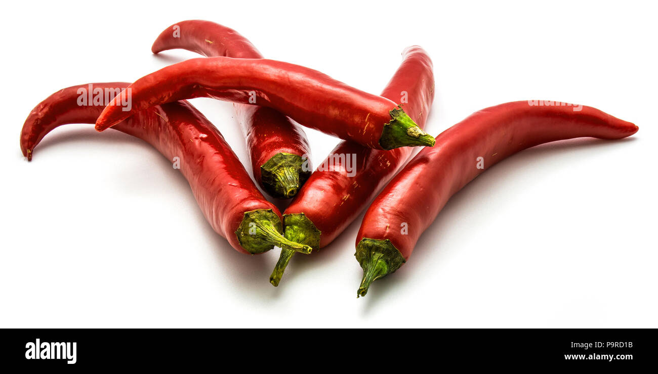 Five red Chili peppers tisolated on white background Stock Photo - Alamy