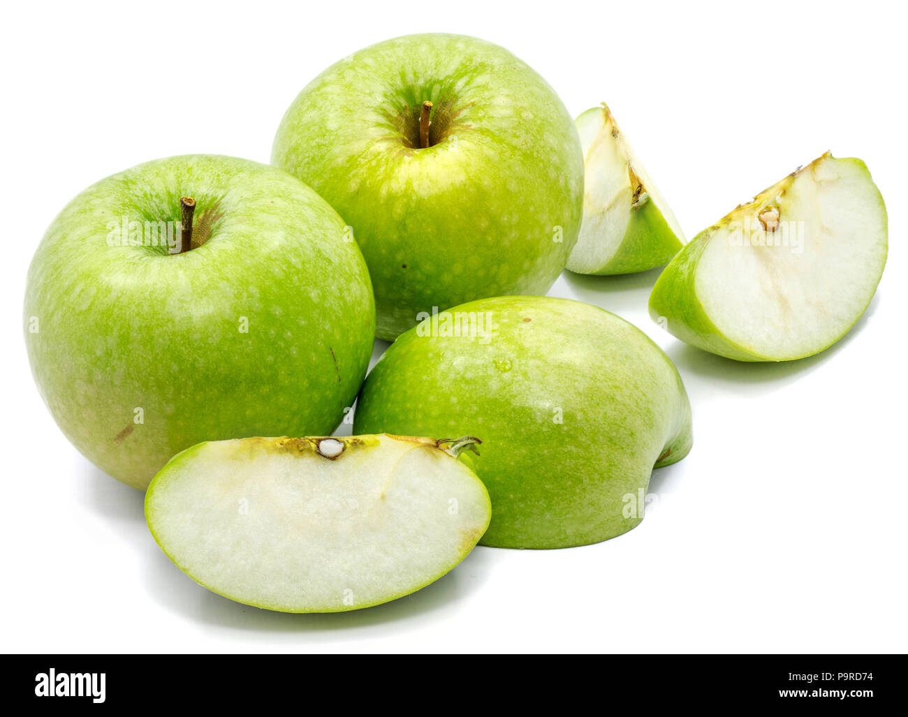 Granny Smith apples, two whole, sliced and one half, isolated on white background Stock Photo