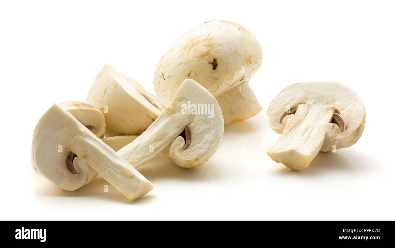 Champignons isolated on white background heap of whole halves and sliced Stock Photo