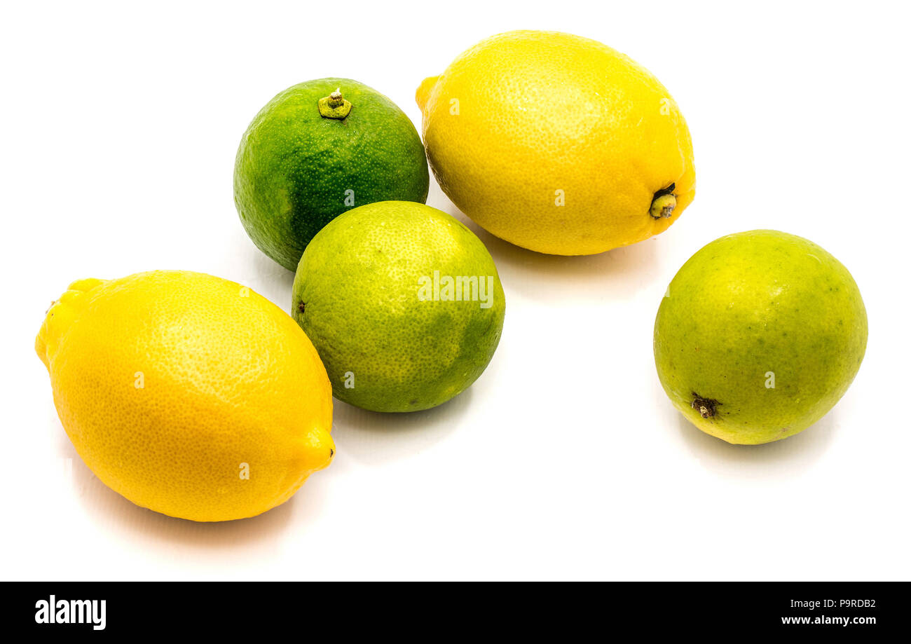 Group of several whole lemons and limes isolated on white background