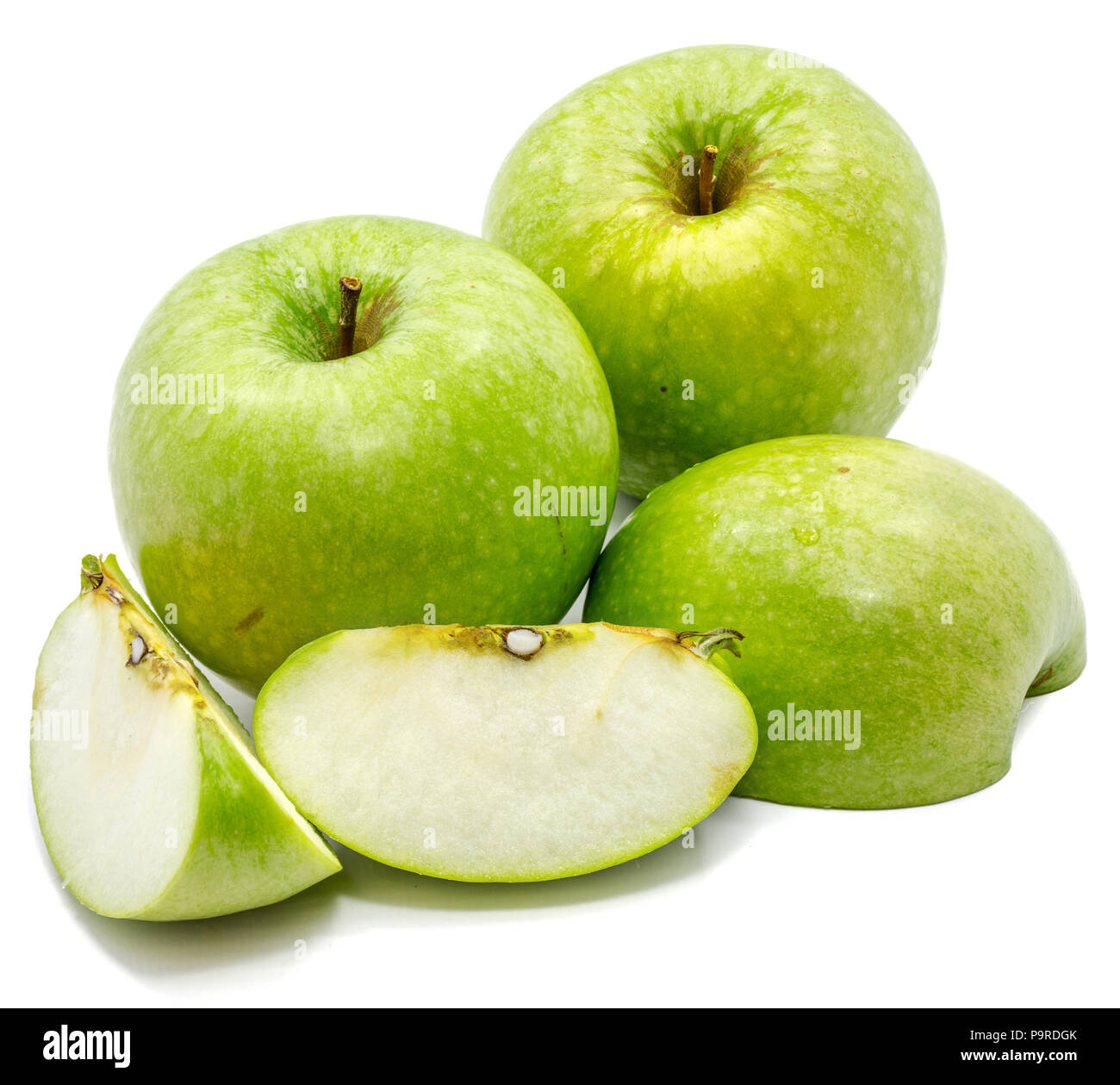 Granny Smith apples, two whole, sliced and one half, isolated on white background Stock Photo