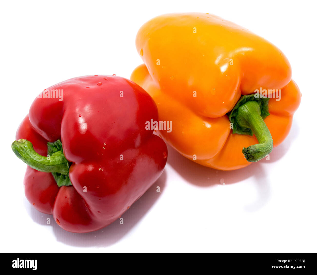 Group of peppers, red and orange pepper on back, isolated on white