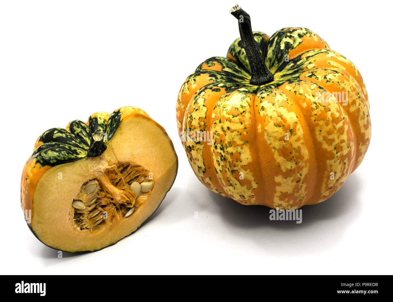One whole spotted green yellow pumpkin and one half isolated on white ...