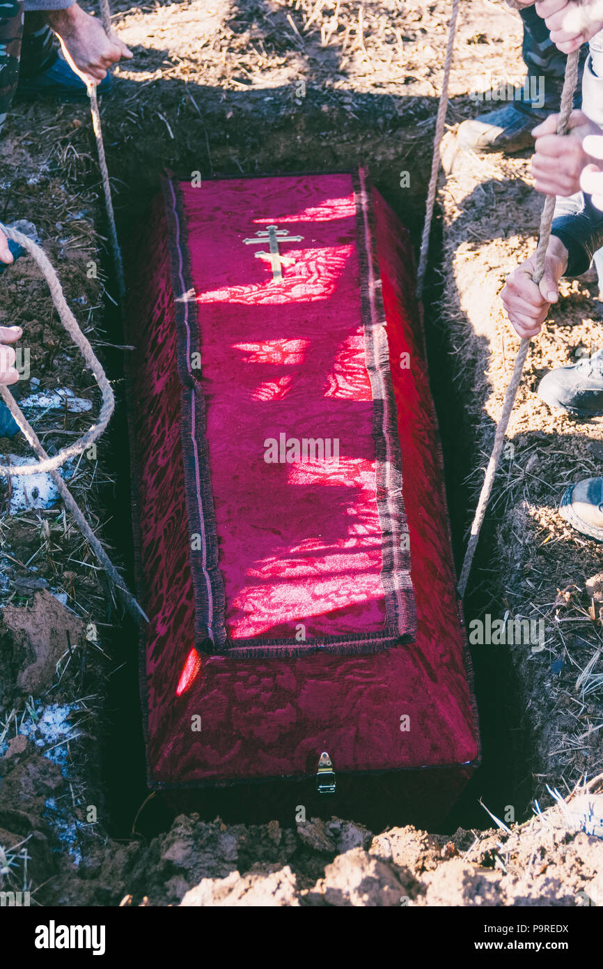 men lowered the coffin into the grave Stock Photo Alamy