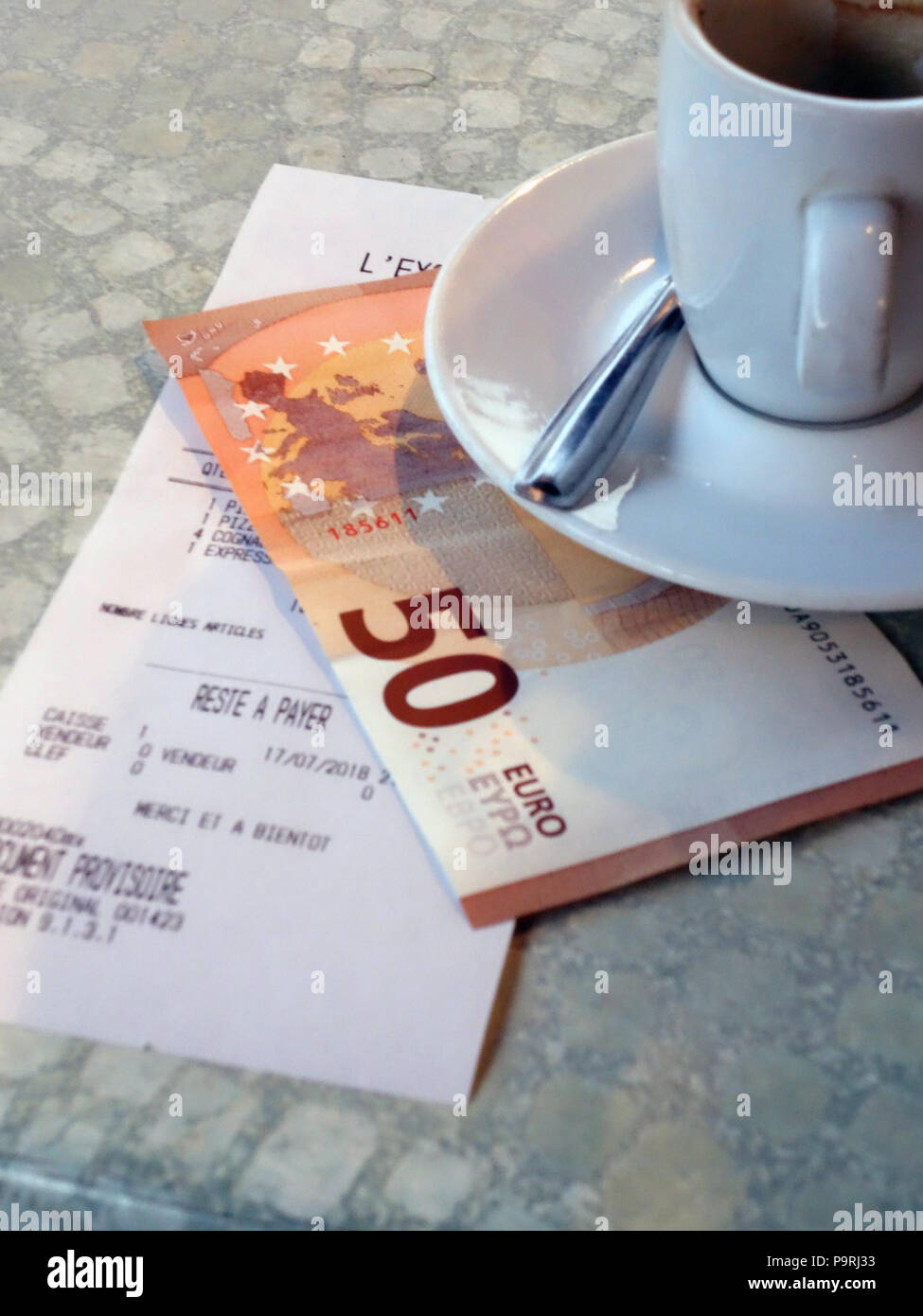 The bill is presented with coffee after dinner in a restaurant in Magalas, Herault, South of France Stock Photo