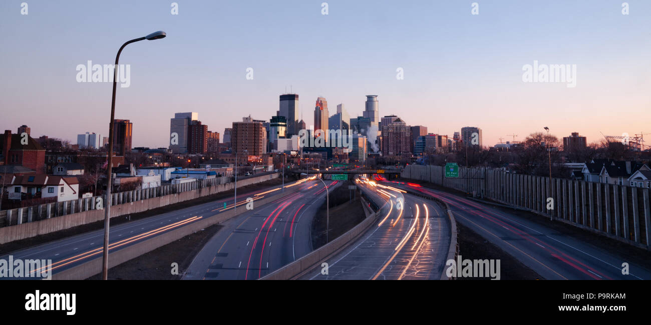 Light streaks are created from headlights and taillights traveling the freeways into Minneapolis Minnesota Stock Photo