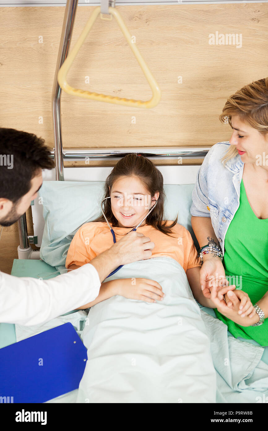 Doctor checking her patient heart in hospital Stock Photo - Alamy