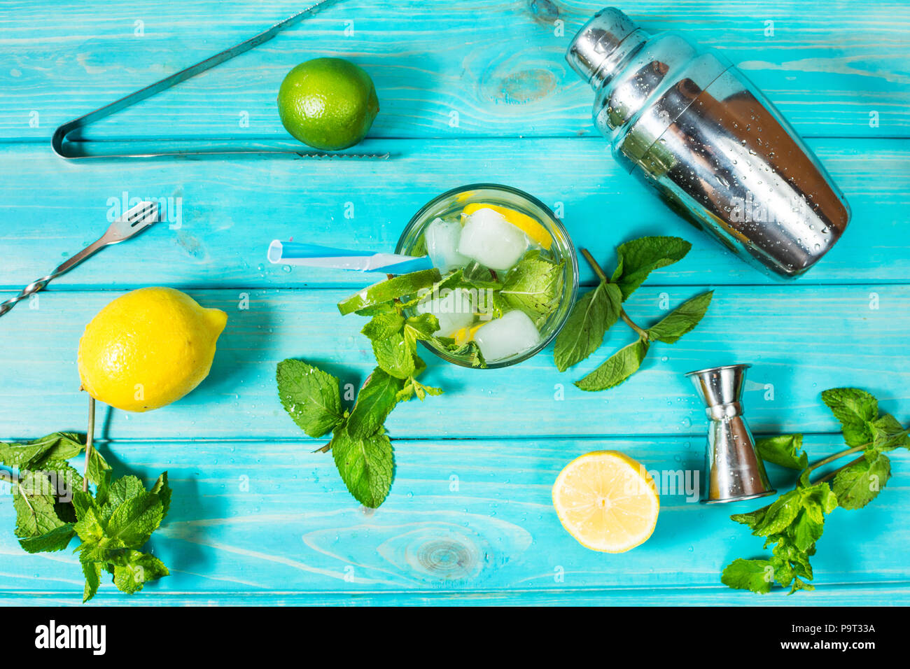 Mojito cocktail with lime and mint in highball glass on a wood table ...