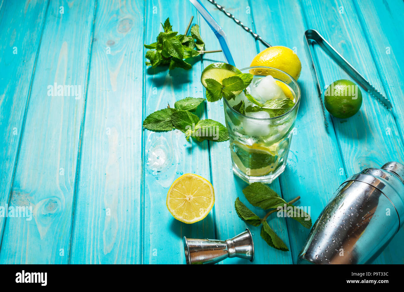 Mojito cocktail with lime and mint in highball glass on a wood table ...